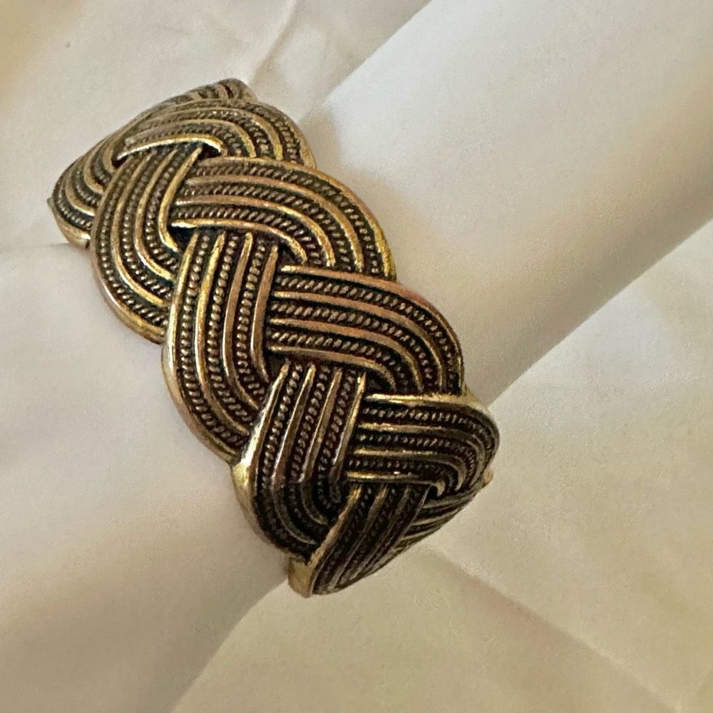 Gold tone hinged braided bangle bracelet